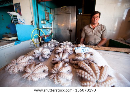 POROS, GREECE - SEP 26: An unidentified seller in market on waterfront in Sep 26, 2012 in Poros, Greece. Poros is a small Greek island-pair, its surface is about 12 sq mi and it has 3,780 inhabitants.