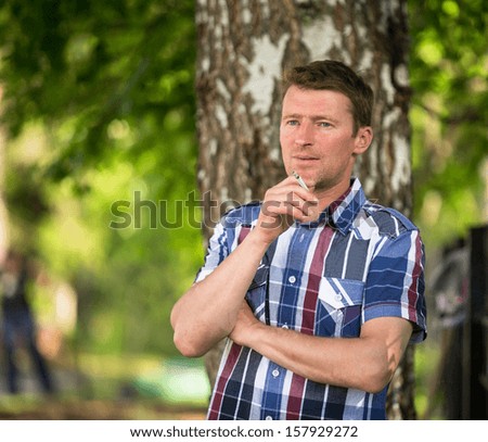 Picture about smoking. Man smoking outdoor.