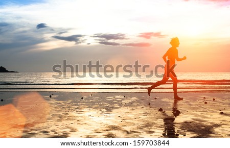 Silhouette Of A Young Woman Jogger At Sunset On The Seashore (With Space For Text)