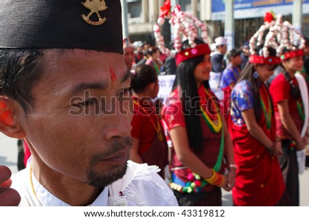 KATHMANDU, NEPAL - DECEMBER 30 2008: Nepalese caste Gurung celebrate their traditional New Year. Procession in traditional costumes goes around the city. Men beat the drums, women dance.