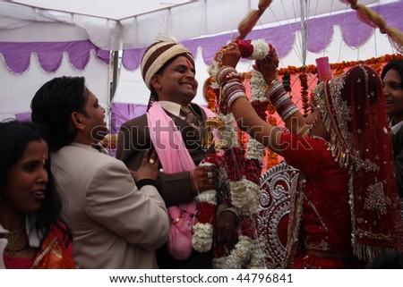 HARIDWAR, INDIA - JANUARY 14: Bride wears a wreath at the groom, which means their betrothal in a traditional Indian wedding, January 14, 2009 in Haridwar, India.