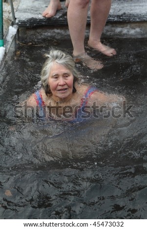 TOMSK, RUSSIA - JANUARY 19: Swimming in the ice-hole, celebration of Epiphany (Holy Baptism) in the Orthodox tradition, January 19, 2010 in Tomsk, Russia.