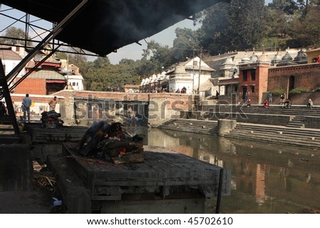 KATHMANDU, NEPAL - JANUARY 2: Cremations in progress at Pashupatinath Temple on the banks of River Baghmati, January 2, 2009 in Kathmandu, Nepal.