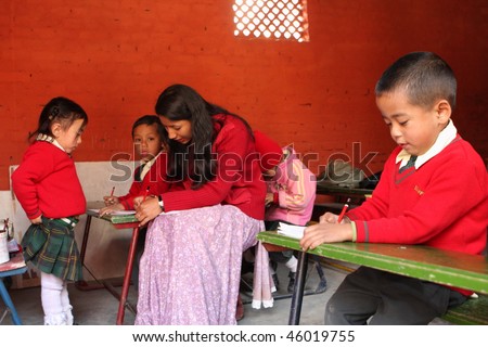 KATHMANDU, NEPAL - JANUARY 1: A teacher conducts lessons in small primary school 