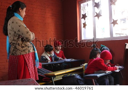 KATHMANDU, NEPAL - JANUARY 1: A teacher conducts lessons in small primary school \