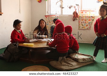 KATHMANDU, NEPAL - JANUARY 1: A teacher conducts lessons in small primary school \