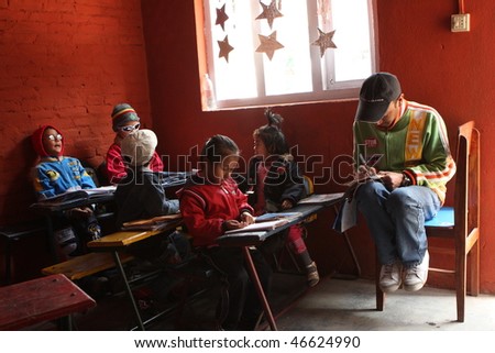 KATHMANDU, NEPAL - JANUARY 1: A teacher conducts lessons in small primary school 