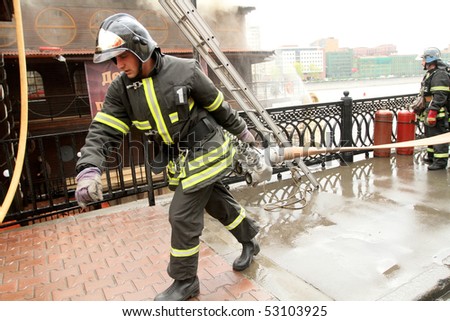 MOSCOW - APRIL 30: Firefighters extinguish fire at the Viking floating restaurant on the Berezhkovskaya embankment, April 30, 2010 in Moscow, Russia.