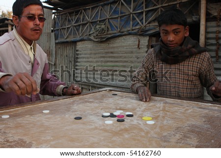 KATHMANDU, NEPAL - JANUARY 7: An unidentified people play chips of a poor area at Old Baneshwor near Bagmati river, January 7, 2009 in Kathmandu Nepal.