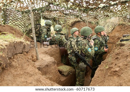 KOSTROMA REGION - AUGUST 26: Infantry soldiers in the dugout on the Command post exercises with 98-th Guards Airborne Division, August 26, 2010 in Kostroma region, Russia.