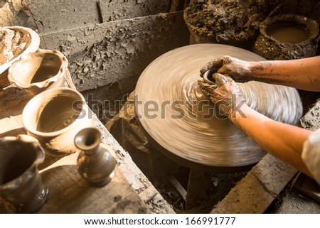 BHAKTAPUR, NEPAL - DEC 7: Unidentified Nepalese man working in the his pottery workshop, Dec 7, 2013 in Bhaktapur, Nepal. 100 cultural groups have created an image Bhaktapur as Capital of Nepal Arts.