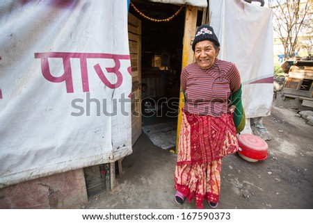 KATHMANDU, NEPAL - DEC 16: Unidentified poor women near their houses at slums in Tripureshwor district, Dec 16, 2013 in Kathmandu, Nepal. Caste of untouchables in Nepal, is about 7 % of population.