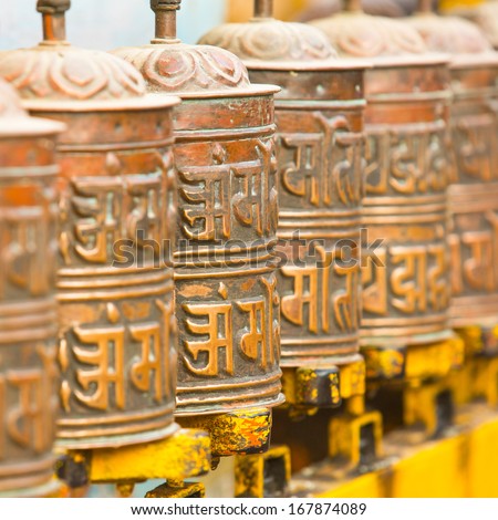Tibetan Buddhist prayer wheels at Boudhanath stupa in Kathmandu, Nepal.