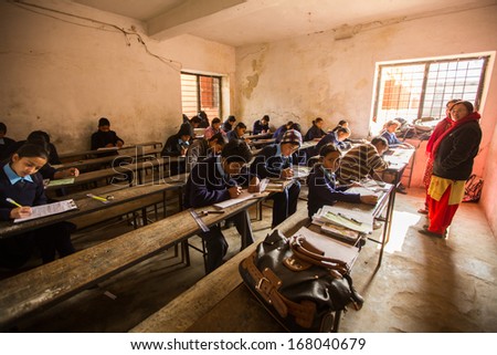 KATHMANDU, NEPAL - DEC 19: Unknown children in the lesson at public school, Dec 19, 2013 in Kathmandu, Nepal. Adult literacy (age 15+) 60.3% (female: 46.3%, male: 73%) in a 2010 population census.