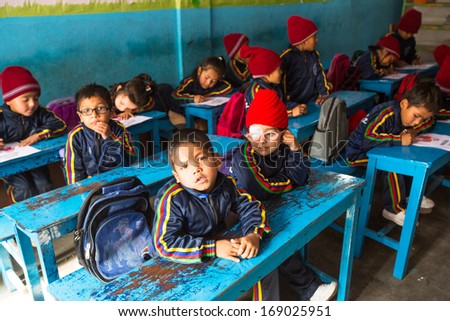 KATHMANDU, NEPAL - DEC 24: Unknown pupils in English class during preparation of the Christmas at primary school, Dec 24, 2013 in Kathmandu, Nepal. Only 50% of  children in Nepal can reach 5 grade.