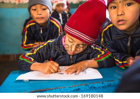 KATHMANDU, NEPAL - DEC 24: Unknown pupils in English class during preparation of the Christmas at primary school, Dec 24, 2013 in Kathmandu, Nepal. Only 50% of  children in Nepal can reach 5 grade.