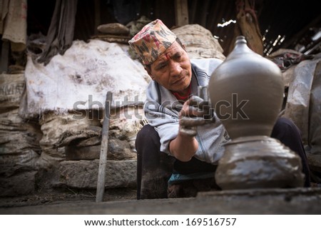 BHAKTAOUR, NEPAL - DEC 7: Unidentified Nepalese man working in his pottery workshop, Dec 7, 2013 in Bhaktapur, Nepal. 100 cultural groups have created the image of Bhaktapur as Capital of Nepal Arts.