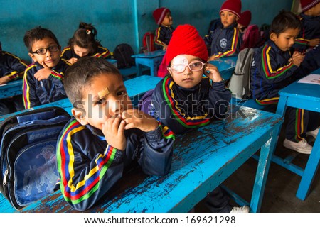 KATHMANDU, NEPAL - DEC 24, 2013: Unknown pupils in English class during preparation of Christmas at primary school, Dec 24, 2013 in Kathmandu, Nepal. Only 50% of  children in Nepal can reach 5th grade.