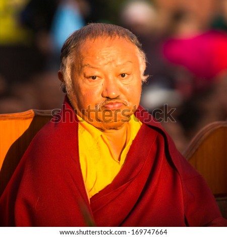 KHATMANDU, NEPAL - DEC 17: Unidentified tibetan Buddhist monk near stupa Boudhanath during festive Puja of H.H. Drubwang Padma Norbu Rinpoche\'s reincarnation\'s, Dec 17, 2013 in Khatmandu, Nepal.
