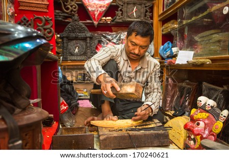 BHAKTAPUR, NEPAL - DEC 5: Unidentified Nepalese man working in the his wood workshop, Dec 5, 2013 in Bhaktapur, Nepal. 100 cultural groups have created an image Bhaktapur as Capital of Nepal Arts.