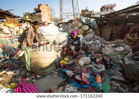 KATHMANDU, NEPAL - DEC 22, 2013: Unidentified people from poorer areas working in sorting of plastic on the dump, Dec 22, 2013 in KTM, Nepal. Only 35% of population have access to adequate sanitation.