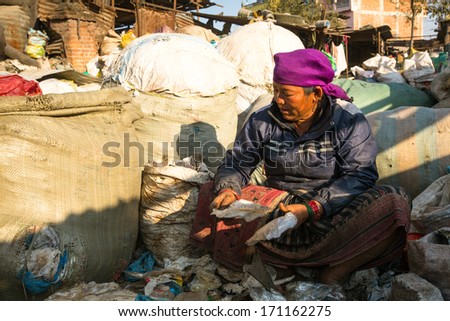 KATHMANDU, NEPAL - DEC 22, 2013: Unidentified woman from poorer areas working in sorting of plastic on the dump, Dec 22, 2013 in KTM, Nepal. Only 35% of population have access to adequate sanitation.