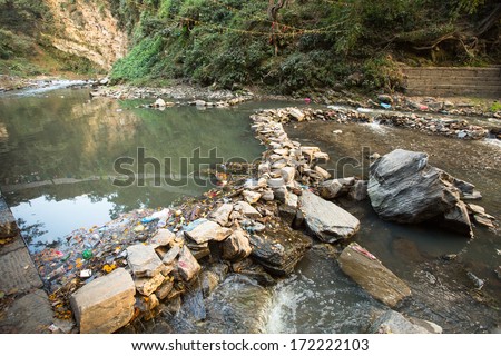 Environmental pollution in the Himalayas. Garbage in the water of Bagmati river.
