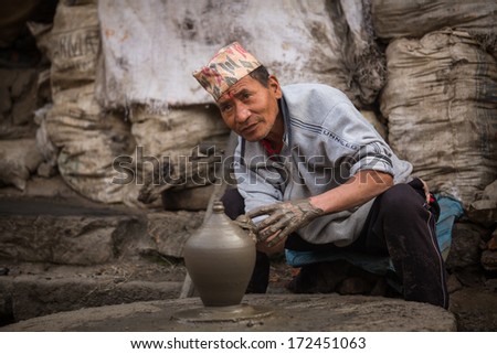 BHAKTAOUR, NEPAL - DEC 7: Unidentified Nepalese man working in the his pottery workshop, Dec 7, 2013 in Bhaktapur, Nepal. 100 cultural groups have created an image Bhaktapur as Capital of Nepal Arts.
