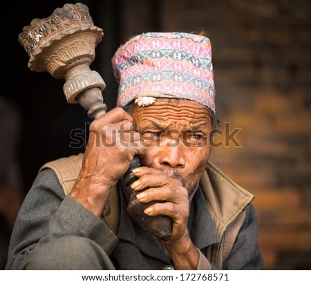 BHAKTAPUR, NEPAL - DEC 7:  Portrait of unidentified Nepalese man smokes on the street, Dec 7, 2013 in Bhaktapur, Nepal. 100 cultural groups have created an image Bhaktapur as Capital of Nepal Arts.