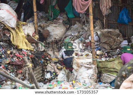KATHMANDU, NEPAL - DEC 19: Unidentified people from poorer areas working in sorting of plastic on the dump, Dec 19, 2013 in Kathmandu, Nepal. Only 35% of population have access to adequate sanitation.