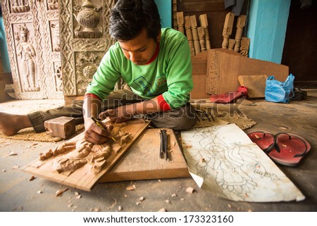 BHAKTAPUR, NEPAL - DEC 19: Unidentified Nepalese man working in the his wood workshop, Dec 19, 2013 in Bhaktapur, Nepal. 100 cultural groups have created an image Bhaktapur as Capital of Nepal Arts.