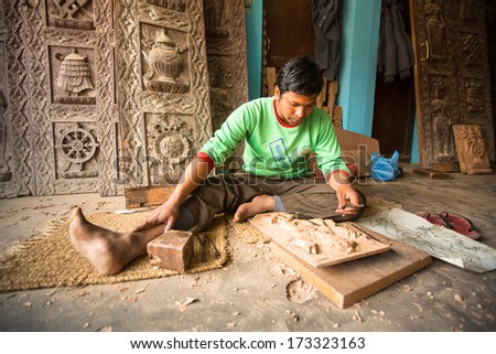 BHAKTAPUR, NEPAL - DEC 19: Unidentified Nepalese man working in the his wood workshop, Dec 19, 2013 in Bhaktapur, Nepal. 100 cultural groups have created an image Bhaktapur as Capital of Nepal Arts.