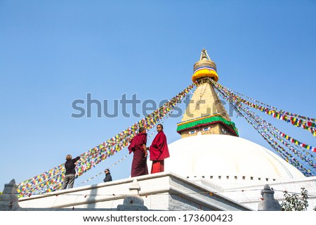 KHATMANDU, NEPAL - DEC 17: Unidentified tibetan Buddhist monks near stupa Boudhanath during festive Puja of H.H. Drubwang Padma Norbu Rinpoche\'s reincarnation\'s, Dec 17, 2013 in Khatmandu, Nepal.