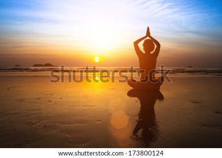 Yoga Woman Sitting On Sea Coast At Sunset.