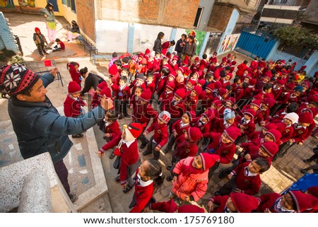 KATHMANDU, NEPAL - DEC 22, 2013: Unknown pupils during dance lesson in primary school. In Nepal only 25% of girls attend schools and half of the children can reach the 5 grade.