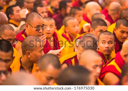 KHATMANDU, NEPAL - DEC 15, 2013: Unidentified tibetan Buddhist monks near stupa Boudhanath during festive Puja of H.H. Drubwang Padma Norbu Rinpoche\'s reincarnation\'s.