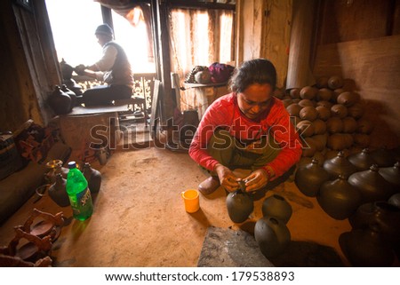 BHAKTAOUR, NEPAL - DEC 7, 2013: Unidentified Nepalese woman working in the her pottery workshop. More 100 cultural groups have created an image Bhaktapur as Capital of Nepal Arts.