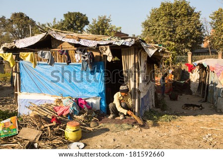 KATHMANDU, NEPAL - DEC 16, 2013: Unidentified poor people near their houses at slums in Tripureshwor district, Kathmandu. Caste of untouchables in Nepal, is about 7 % of population.