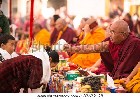 KHATMANDU, NEPAL - DEC 17, 2013: Unidentified tibetan Buddhist monks near stupa Boudhanath during festive Puja of H.H. Drubwang Padma Norbu Rinpoche\'s reincarnation\'s.