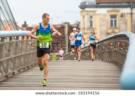 KRAKOW, POLAND - MAR 23, 2014: Unidentified participants during the annual Krakow  international Marathon. Krakow Marathon conducted since 2002 under the slogan: With history in the background.