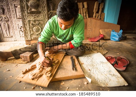 BHAKTAPUR, NEPAL - DEC 19, 2013: Unidentified Nepalese man working in the his wood workshop. More 100 cultural groups have created an image Bhaktapur as Capital of Nepal Arts.