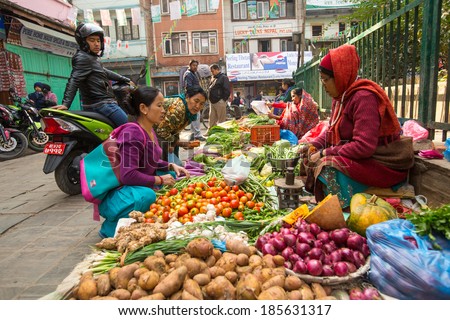 KATHMANDU, NEPAL - NOV 28, 2013: Unidentified street vendor in historic center of city. Largest city of Nepal, its economic center, a population of over 1 million people.