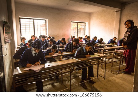 KATHMANDU, NEPAL - DEC 19, 2013: Unknown children in the lesson at public school. Adult literacy (age 15+) 60.3% (female: 46.3%, male: 73%) in a 2010 population census.