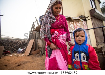 KATHMANDU, NEPAL - DEC 19, 2013: Unidentified local children near their homes in a poor area of the city. The caste system is still intact today but the rules are not as rigid as they were in the past