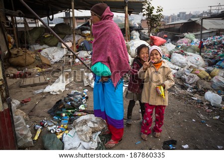 KATHMANDU, NEPAL - DEC 19, 2013: Unidentified local children near their homes in a poor area of the city. The caste system is still intact today but the rules are not as rigid as they were in the past