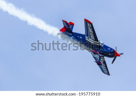 BERLIN, GERMANY - MAY 21, 2014: A Extra-300, D-EAXK- two-seat aerobatic plane (Germany), demonstration during the International Aerospace Exhibition ILA Berlin Air Show-2014.