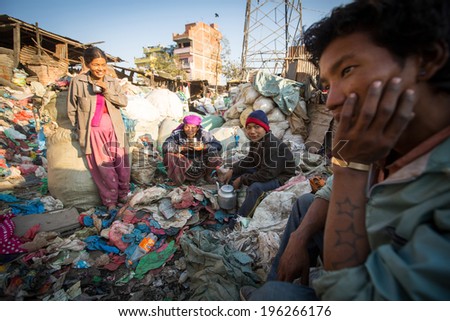 KATHMANDU, NEPAL - DEC 22, 2013: Unidentified people from poorer areas working in sorting of plastic on the dump. Only 35% of population have access to adequate sanitation.