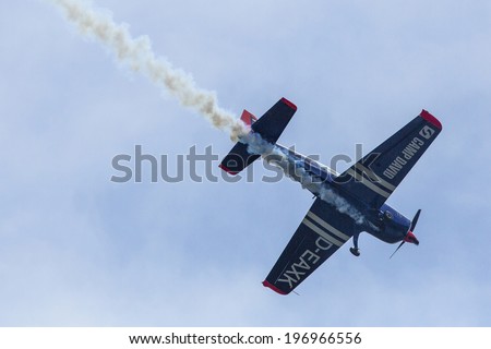 BERLIN, GERMANY - MAY 21, 2014: A Extra-300, D-EAXK- two-seat aerobatic plane (Germany), demonstration during the International Aerospace Exhibition ILA Berlin Air Show-2014.