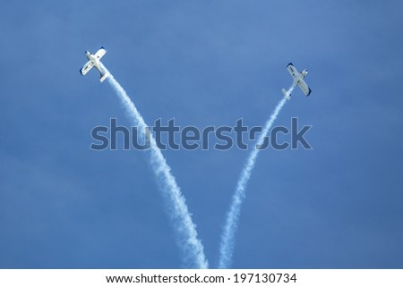 BERLIN, GERMANY - MAY 21, 2014: Aerobatic team 3x Fly Sinthesis Texan Top Class (Wefly team, Italy) demonstration during the International Aerospace Exhibition ILA Berlin Air Show-2014.