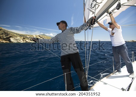 AEGEAN SEA, GREECE - APR 29, 2014: Unidentified sailors participate in sailing regatta \